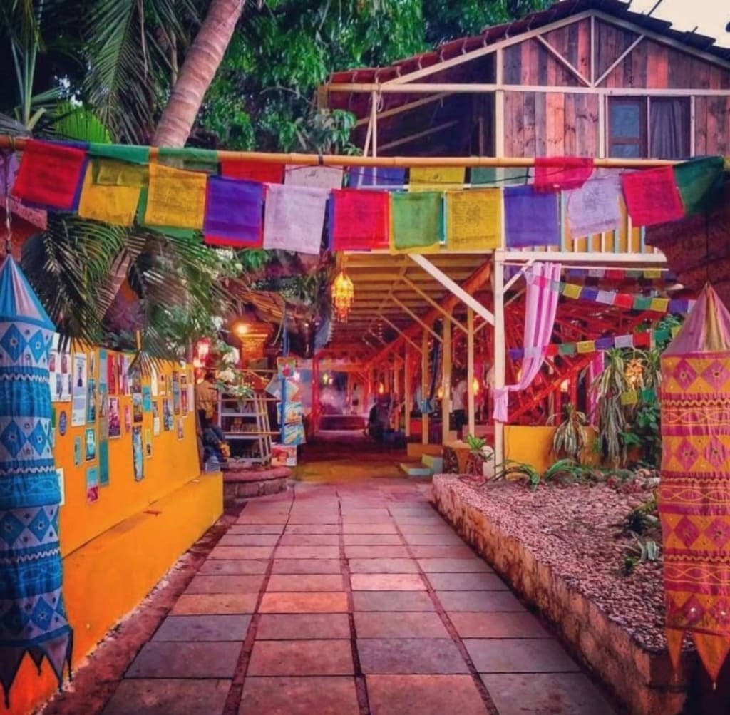 Colourful walkway with lanterns and prayer flags leading into German Bakery, Anjuna